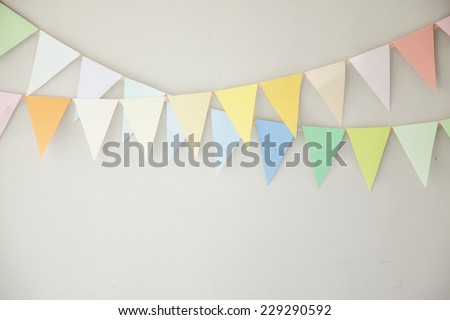colorful buntings on wall, green, red, yellow, blue and white