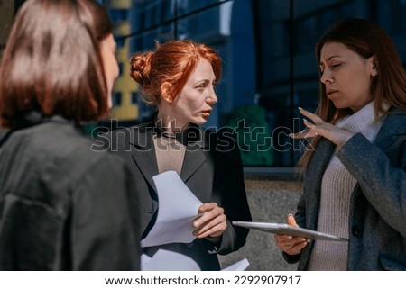 A shot of blonde businesswoman gesticulating with her hand while explaining a project problem solution to her colleagues. Ginger businesswoman looking at ther and listening Royalty-Free Stock Photo #2292907917