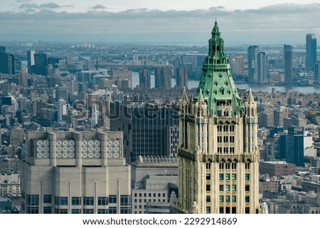New York City, USA - A breathtaking aerial view captures The Woolworth Building with a cloudy sky and the other skyscrapers of the city in the background. Magnificent neo-Gothic structure