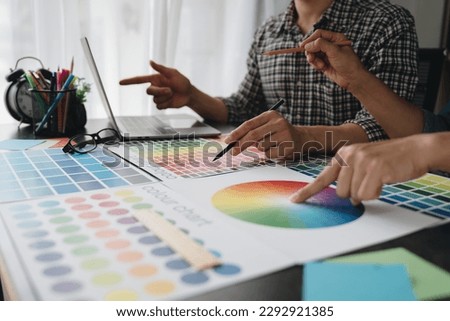Engineers, graphics, architects and painters are meeting to discuss and record details about paint textures. The color tone on the color sheet to match the appropriate structure plan.