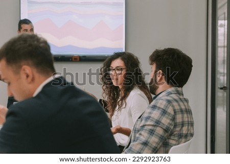 Close up of beautiful business woman wondering about the conversation with her colleague while sitting at the conference room