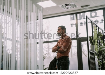 A side view photo of a stylish business person talking to his colleagues at work