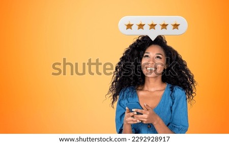 Happy black woman with phone in hands, empty copy space orange background. Positive review from customer, giving five stars bubble feedback online. Concept of rating and best service