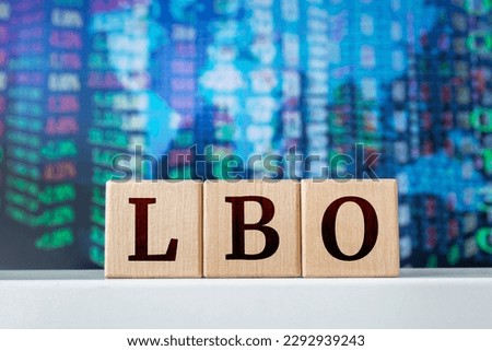 LBO - acronym from wooden cubes with letters, Leveraged Buyout. Financial market concept