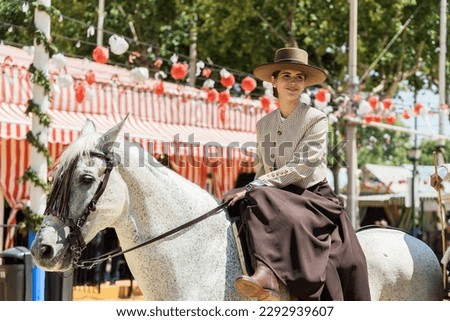 Young woman in traditional dress riding a horse at the seville fair