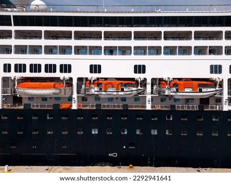 Lifeboats on a cruise ship are a crucial safety feature, ensuring passengers can evacuate safely in an emergency. They are strategically placed and equipped with supplies, ready for any situation Royalty-Free Stock Photo #2292941641