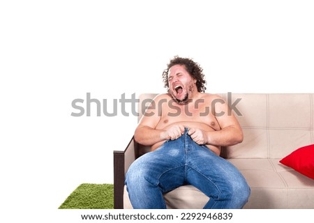 Funny fat man is sitting on the couch. Diet and healthy lifestyle.	 Royalty-Free Stock Photo #2292946839