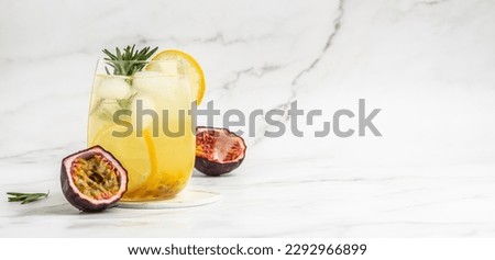 passionfruit cocktail. Tropical drink for summer party. on a light background, refreshing drink or beverage with ice, place for text. Royalty-Free Stock Photo #2292966899