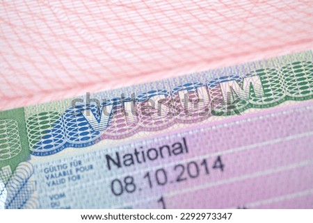close-up part of page of document, foreign passport for travel with European visa, national visa stamp with shallow depth of field, migration law, passport control at border, concept emigration