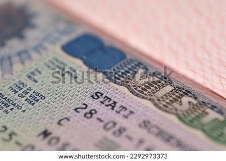close-up page of document, foreign passport for travel with European visa, tourist italian schengen visa stamp with hologram with shallow depth of field, passport control at border, travel in Europe