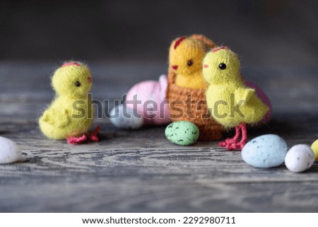 Knitted chickens on a wooden background
