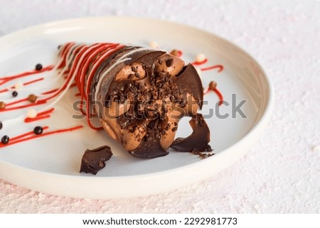 Cocoa and caramel cornet ice cream designed with decorative candy in a white plate Royalty-Free Stock Photo #2292981773