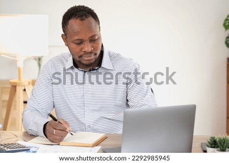 African American businessman smiling relaxed and crossed arms after analysis and research at home office