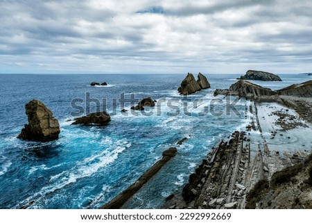Wave-cut abrasion platform in La Arnia beach, Liencres, Costa Quebrada, Broken Coast, Cantabria, Spain Royalty-Free Stock Photo #2292992669
