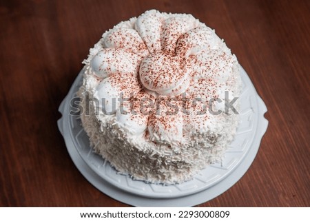 Biscuit baked cake with cream. Pastry. On a wooden table