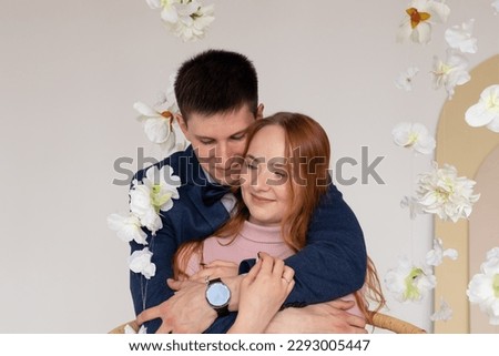 Cheerful smiling couple in love hugging indoor