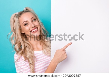 Photo of young cheerful attractive girl direct finger banner recommend cheap price proposition enjoy stomatology isolated on cyan color background