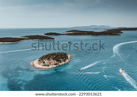 This aerial view captures the stunning beauty of the Paklinski Islands, located near Hvar, Croatia. With turquoise waters and luxury yachts dotting the bays, this archipelago is a true paradise. Royalty-Free Stock Photo #2293013621