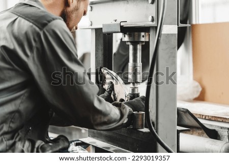 Close up of automechanic changing the silent block in the hydraulic press in the car service Royalty-Free Stock Photo #2293019357