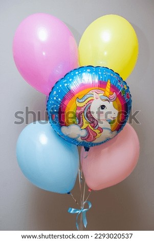 colorful balloons with a unicorn pattern on a white background