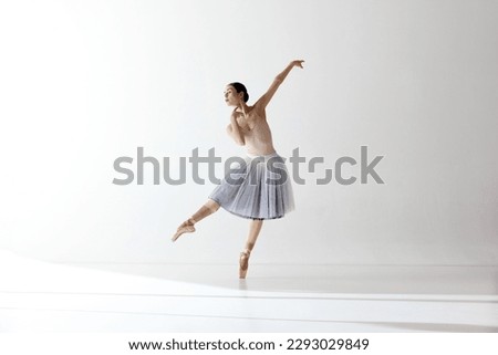 Graceful ballerina, ballet. Beautiful woman ballet dancer dancing over white background. Art, motion, action, flexibility, inspiration concept. Beauty of contemporary dance Royalty-Free Stock Photo #2293029849