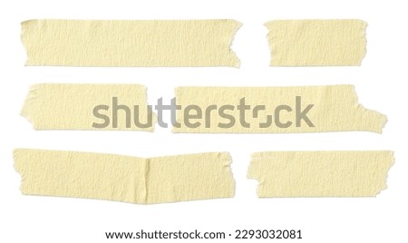 six pieces or strips of ripped yellow textured adhesive kraft paper masking tape, attach something or use as labels and add some text - isolated design element Royalty-Free Stock Photo #2293032081