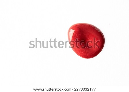 Bright red lipstick smear, lips make up and cosmetic swatch on white background.