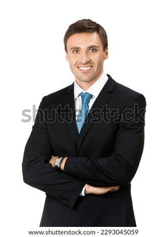 Studio portrait image of smiling young businessman in black suit and blue tie necktie, with crossed arms, isolated isolate over white background. Business man at studio picture.  Royalty-Free Stock Photo #2293045059