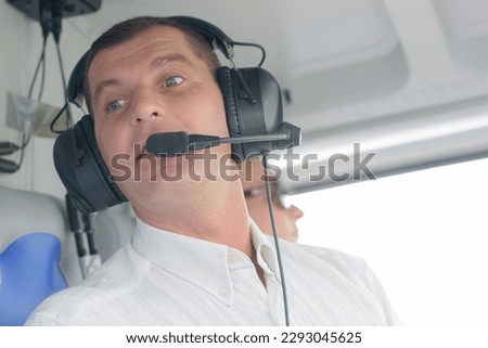 a newscaster broadcasting from helicopter Royalty-Free Stock Photo #2293045625