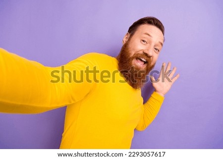 Photo selfie of funky guy wear yellow pullover blogging shooting cadre laugh demonstrate empty space ad isolated on violet color background