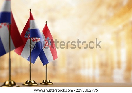 Small flags of the Croatia on an abstract blurry background.