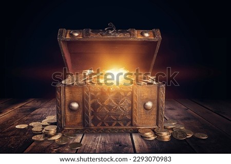 Glowing bright light from open dark treasure chest