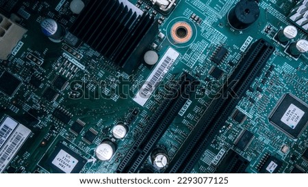A motherboard is the main printed circuit board (PCB) in a computer. The motherboard is a computer's central communications backbone connectivity point, through which all components and external perip Royalty-Free Stock Photo #2293077125