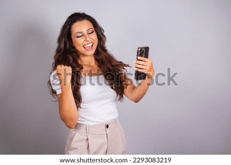 beautiful brazilian woman holding smartphone, using cell phone, apps.