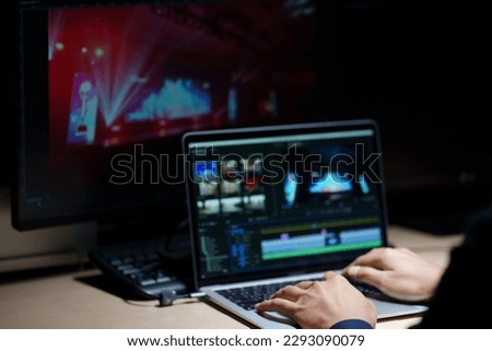 video editor working with footage and sound, editing new project cutting film montage sitting in modern agency office. man using computer processing movie in post production software