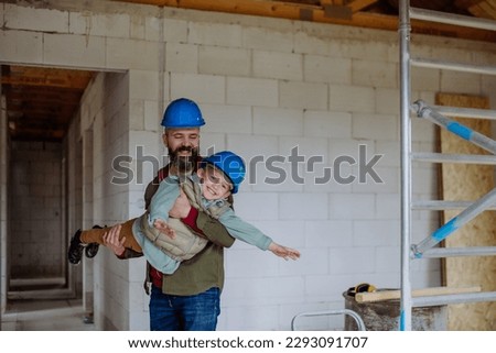 Father and his little son having fun in their unfinished house. Royalty-Free Stock Photo #2293091707