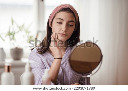 Teenage girl doing her skin care routine. Royalty-Free Stock Photo #2293091989