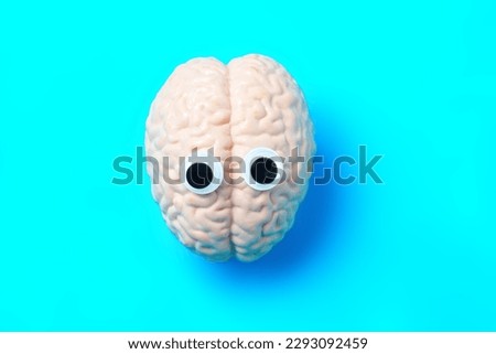 Cartoonish human brain character with googly eyes against a blue background. Fun and engaging visual representation of the human brain and innovation related concept.