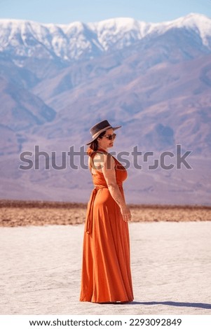 Woman with a red dress enjoys the view at Badwater Basin Death Valley California