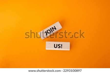 Join us symbol. Concept word Join us on wooden blocks. Beautiful orange background. Business and Join us concept. Copy space Royalty-Free Stock Photo #2293100897