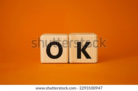 Ok symbol. Concept word Ok on wooden cubes. Beautiful orange background. Business and Ok concept. Copy space.