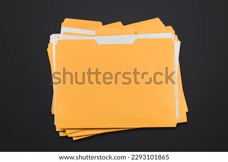 Yellow office file with documents on black table Royalty-Free Stock Photo #2293101865