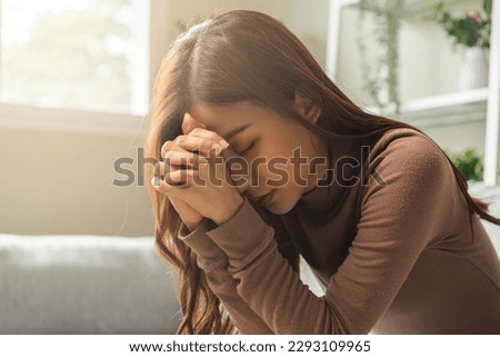 Believe faith charity, calm asian young woman show gratitude, folded hands in prayer feel grateful, meditating with her eyes closed, praying to request God for help. Religious, forgiveness concept. Royalty-Free Stock Photo #2293109965