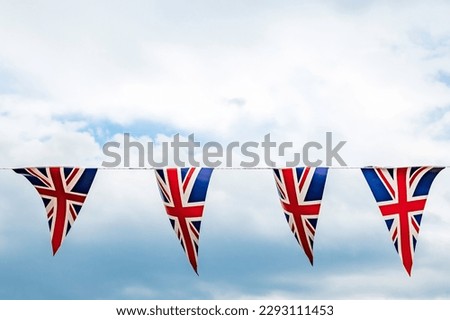 Union Jack bunting, against a summers sky Royalty-Free Stock Photo #2293111453