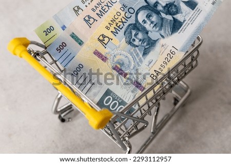 Financial concept, Mexico inflation rate, store prices, Empty shopping cart and mexican pesos money
