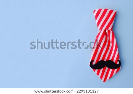 Striped red and white tie with black retro mustache is an example of the design of a gift card for Father's Day, Boss's Day, sale of ties, accessories in men's stores, gift design.Copyspace
