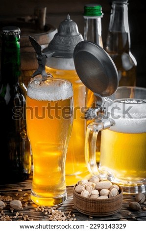 Light beer in a glass on an old background.