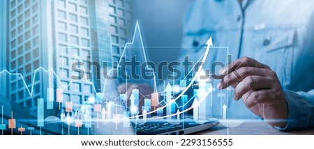 Businessman analyzes profitability of working companies with digital augmented reality graphics, positive indicators in 2024, businessman calculates financial data for long-term investments. Royalty-Free Stock Photo #2293156555
