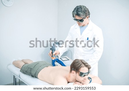 Doctor working on patients back in a rehabilitation center