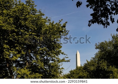 Washington, DC, USA - May 17, 2022: View of obelisk and plants at Lincoln Monument in sunny day.